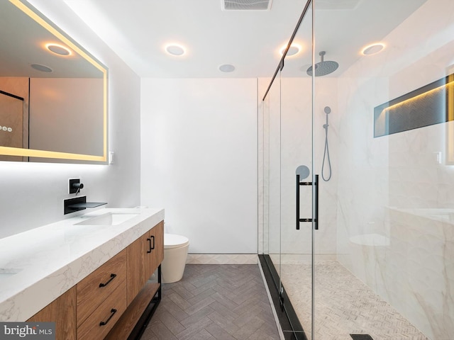 bathroom with visible vents, a shower stall, toilet, and vanity