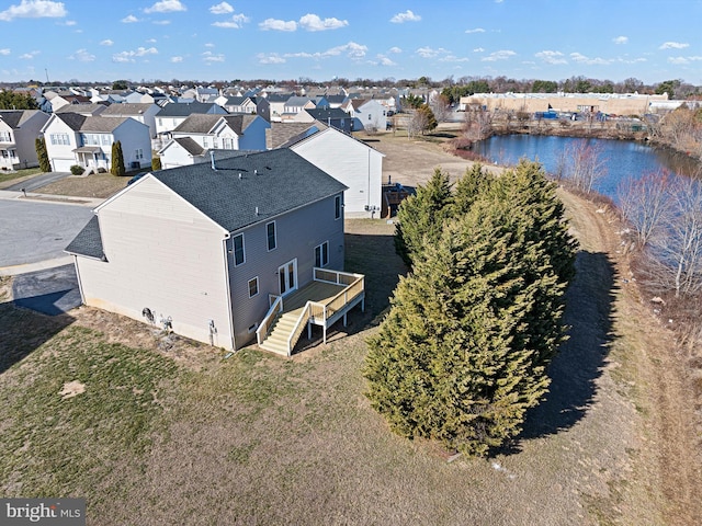 drone / aerial view with a residential view and a water view