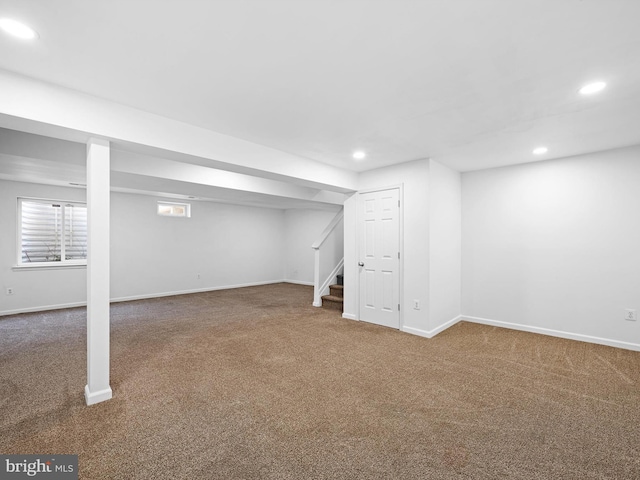 below grade area featuring recessed lighting, carpet flooring, baseboards, and stairs