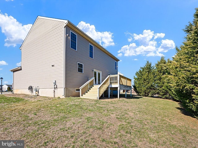 rear view of house with stairway, a lawn, and a wooden deck