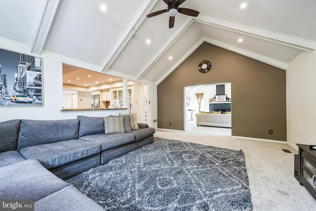 living area featuring beamed ceiling, carpet floors, high vaulted ceiling, and ceiling fan