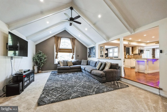 living area featuring baseboards, vaulted ceiling with beams, recessed lighting, ceiling fan, and light colored carpet