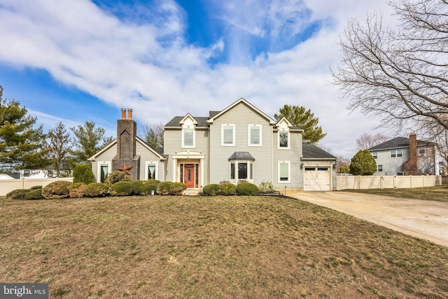 traditional home with a garage, a front lawn, driveway, and fence