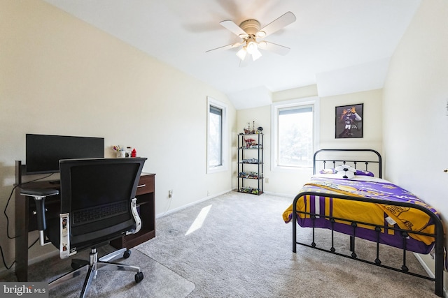 carpeted bedroom featuring vaulted ceiling, baseboards, and ceiling fan