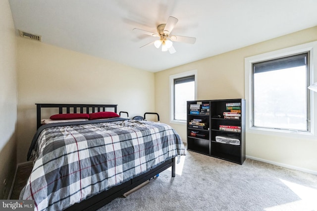 bedroom featuring visible vents, baseboards, a ceiling fan, and carpet flooring