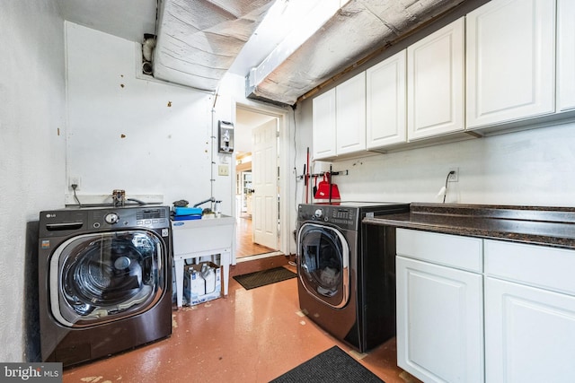 laundry area with washer and dryer and cabinet space