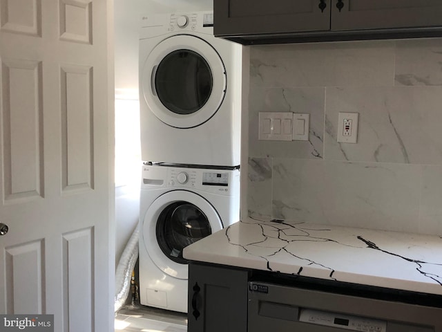 laundry room featuring laundry area and stacked washer / drying machine