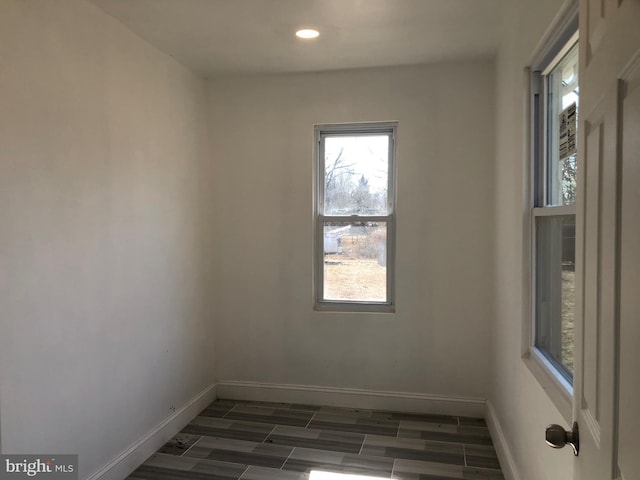 unfurnished room featuring recessed lighting, baseboards, and wood tiled floor