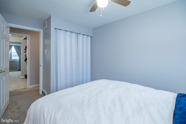 bedroom with visible vents, a ceiling fan, a closet, carpet, and baseboards