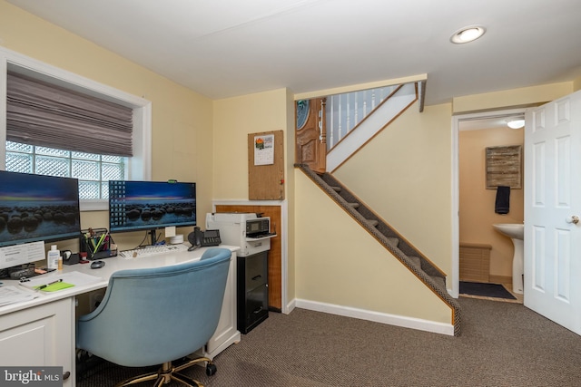 home office featuring dark colored carpet and baseboards