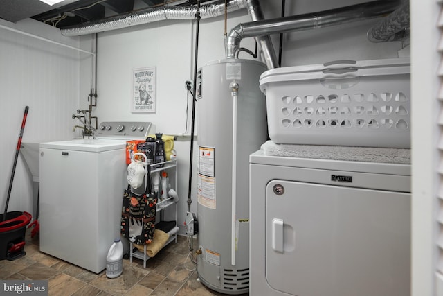 utility room with washer and dryer and water heater