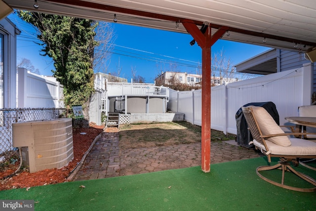 view of patio / terrace with central AC unit and a fenced backyard