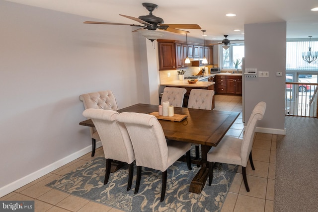 dining area featuring light tile patterned flooring, recessed lighting, baseboards, and a chandelier