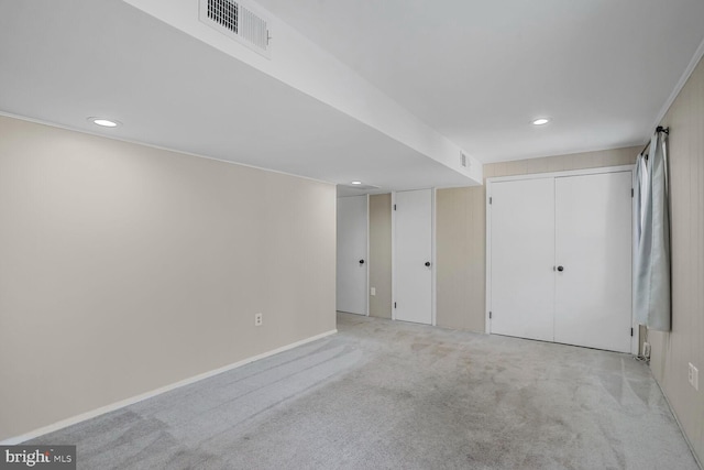 finished below grade area featuring recessed lighting, visible vents, and light colored carpet