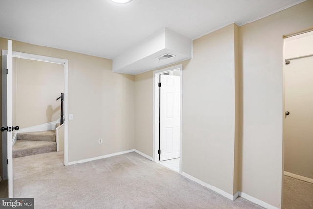 basement featuring carpet flooring, baseboards, and visible vents