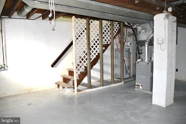 unfinished below grade area with gas water heater, stairway, and heating unit