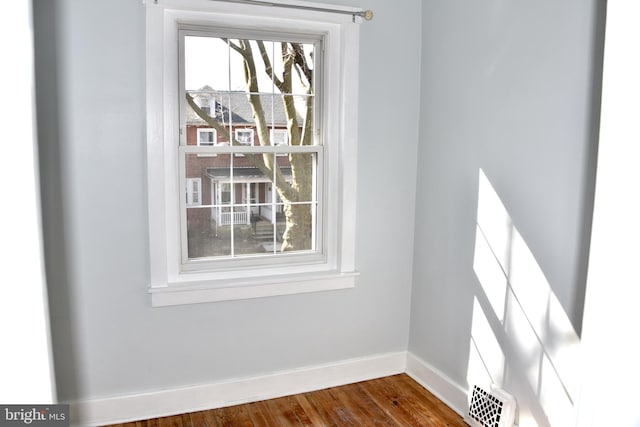 room details featuring visible vents, baseboards, and wood finished floors