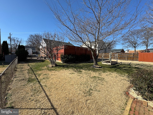 view of yard with an outbuilding and fence