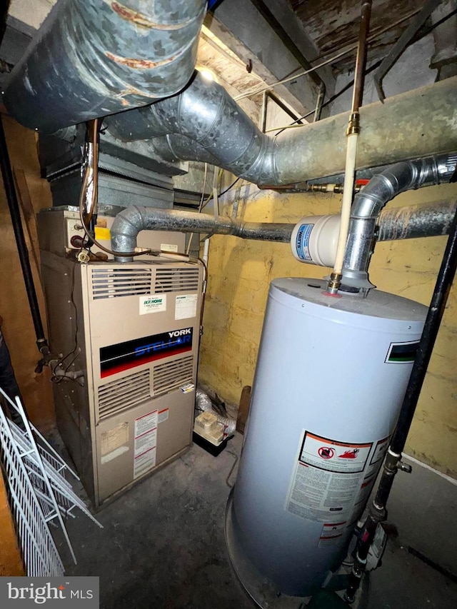 utility room with heating unit and gas water heater