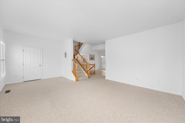 interior space featuring stairway, baseboards, and visible vents