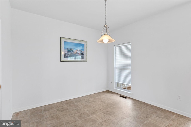 unfurnished room featuring visible vents and baseboards