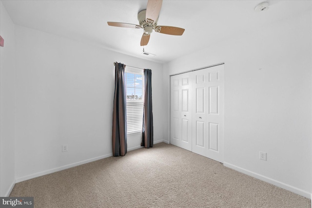 unfurnished bedroom with a closet, visible vents, baseboards, and carpet floors