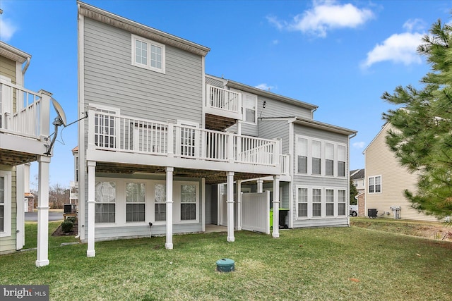 rear view of property featuring a deck and a yard