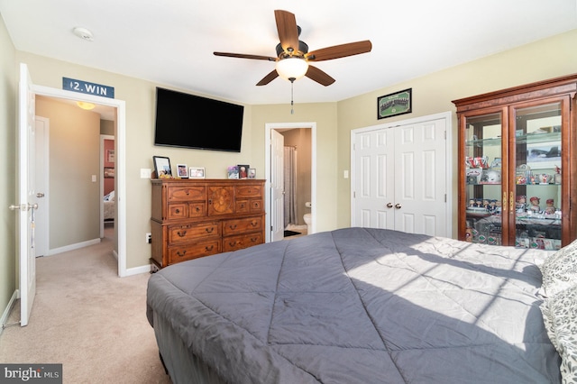 bedroom with connected bathroom, baseboards, ceiling fan, and carpet flooring