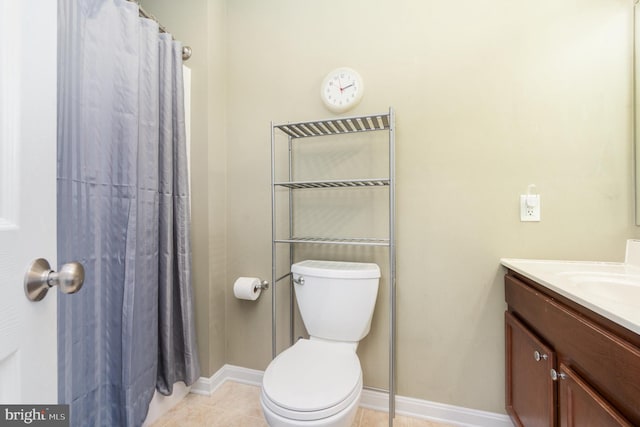 bathroom with tile patterned floors, toilet, vanity, and baseboards