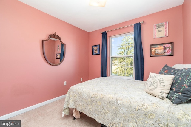 bedroom with baseboards and carpet