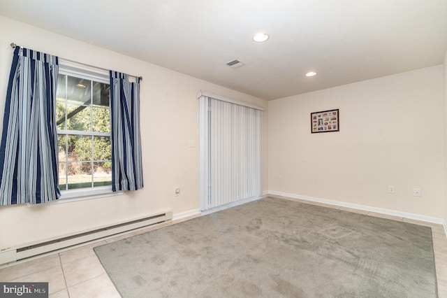 tiled empty room featuring visible vents, recessed lighting, baseboards, and baseboard heating