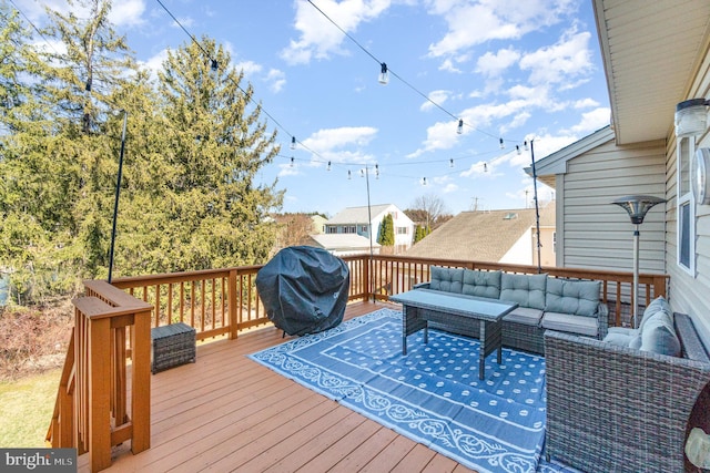 wooden terrace with outdoor lounge area and a grill