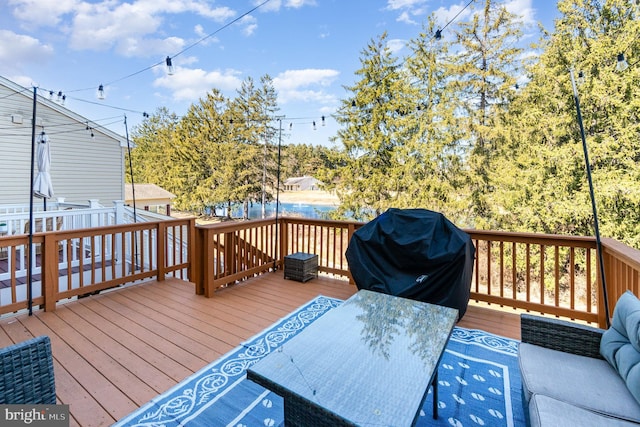 deck with grilling area and outdoor dining space