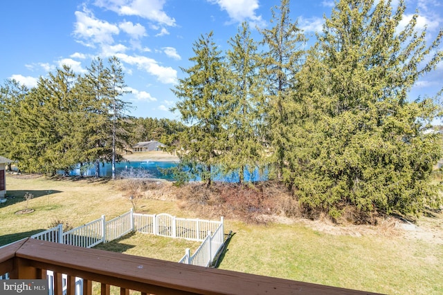 view of yard featuring fence and a water view