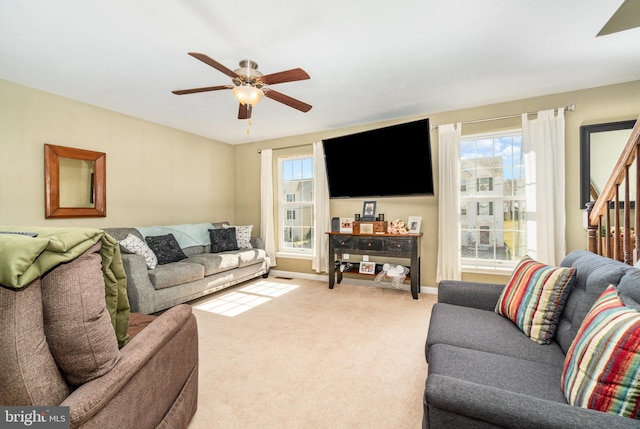 living room with carpet flooring, baseboards, and ceiling fan