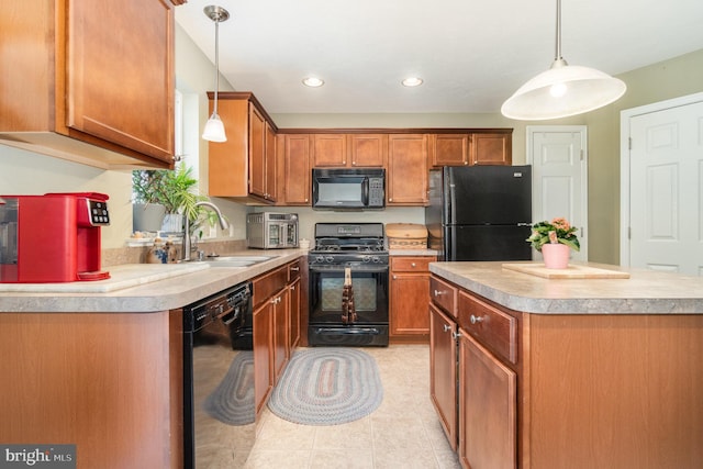 kitchen featuring a center island, light countertops, brown cabinetry, black appliances, and a sink