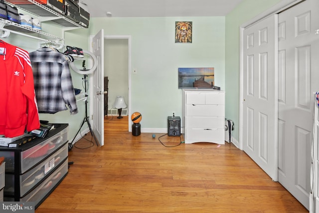 interior space with baseboards and wood finished floors