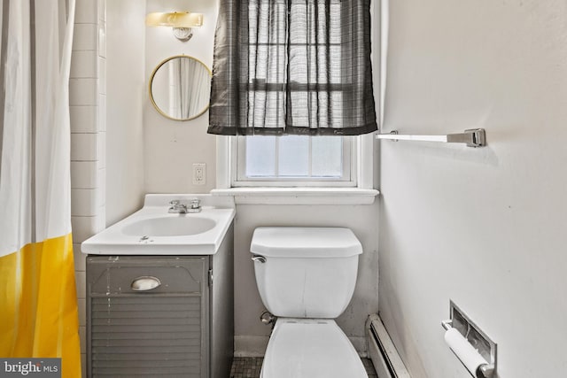 bathroom with toilet, vanity, and a baseboard radiator