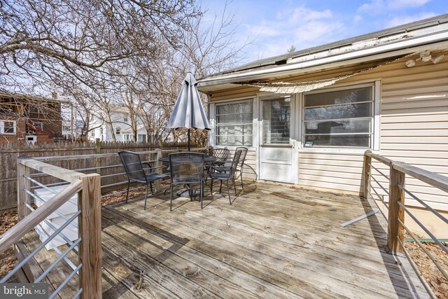 deck featuring outdoor dining space and fence