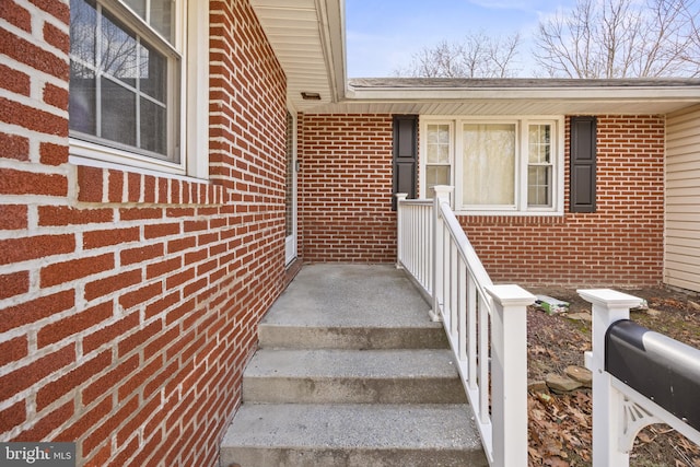 property entrance with brick siding