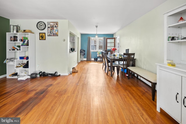 dining room with light wood-style flooring and baseboards