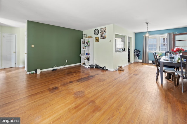 dining space featuring hardwood / wood-style flooring and baseboards