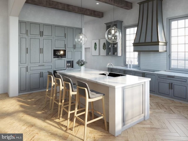 kitchen with premium range hood, a kitchen island with sink, a sink, decorative backsplash, and black electric stovetop