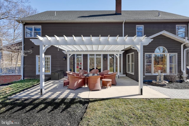 rear view of house with a patio area, a chimney, a pergola, and a shingled roof