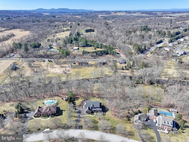 birds eye view of property featuring a mountain view and a forest view