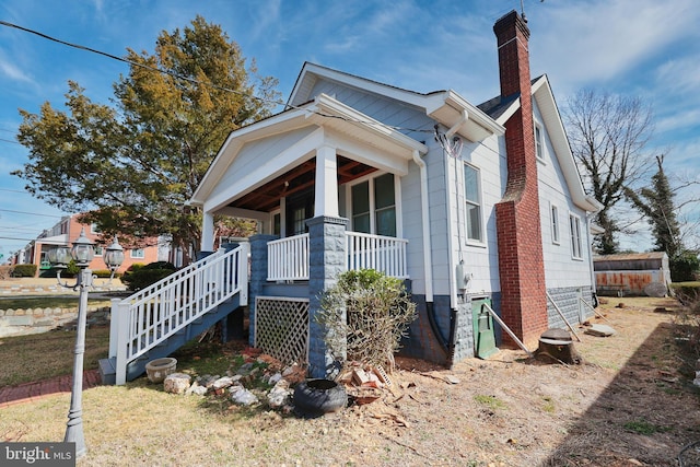 exterior space featuring covered porch and a chimney