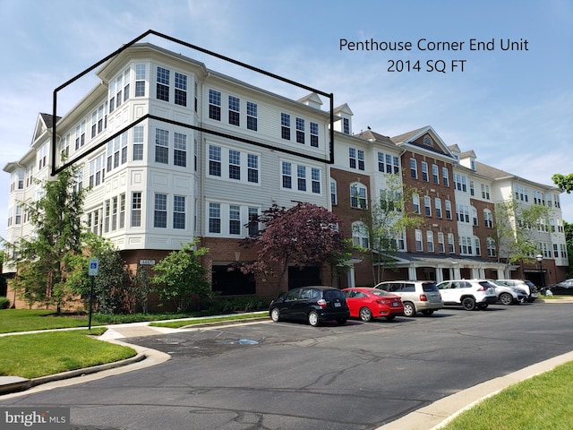 view of property featuring uncovered parking