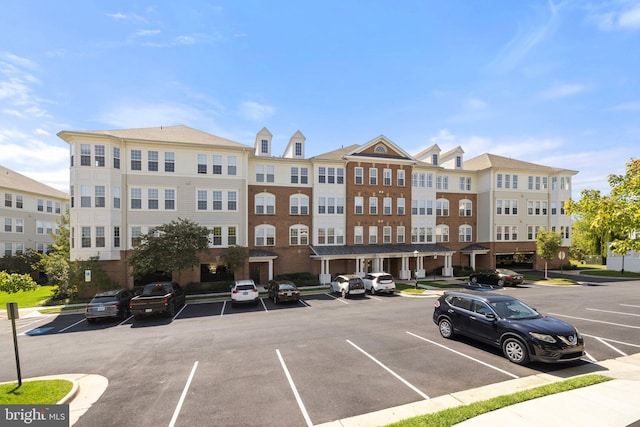 view of building exterior featuring uncovered parking