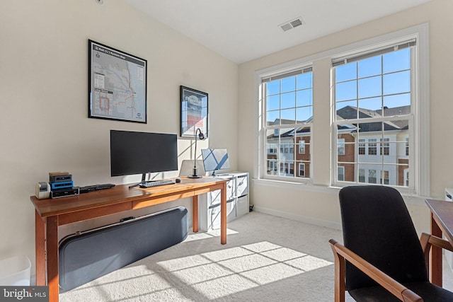 carpeted home office with visible vents and baseboards