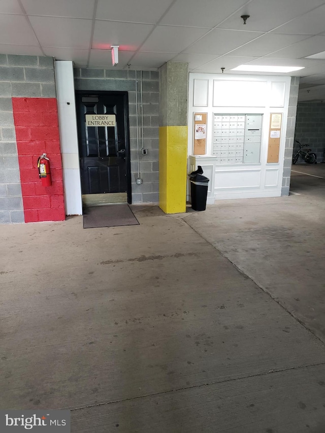 parking garage featuring concrete block wall